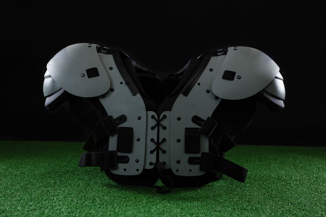 Close-up of American Football Shoulder Pads on Artificial Turf - Free Images, Stock Photos and Pictures on Pikwizard.com