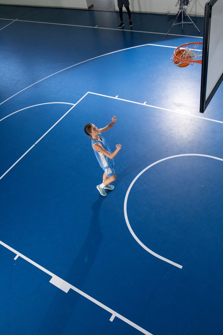 Female Basketball Player in Action on Court