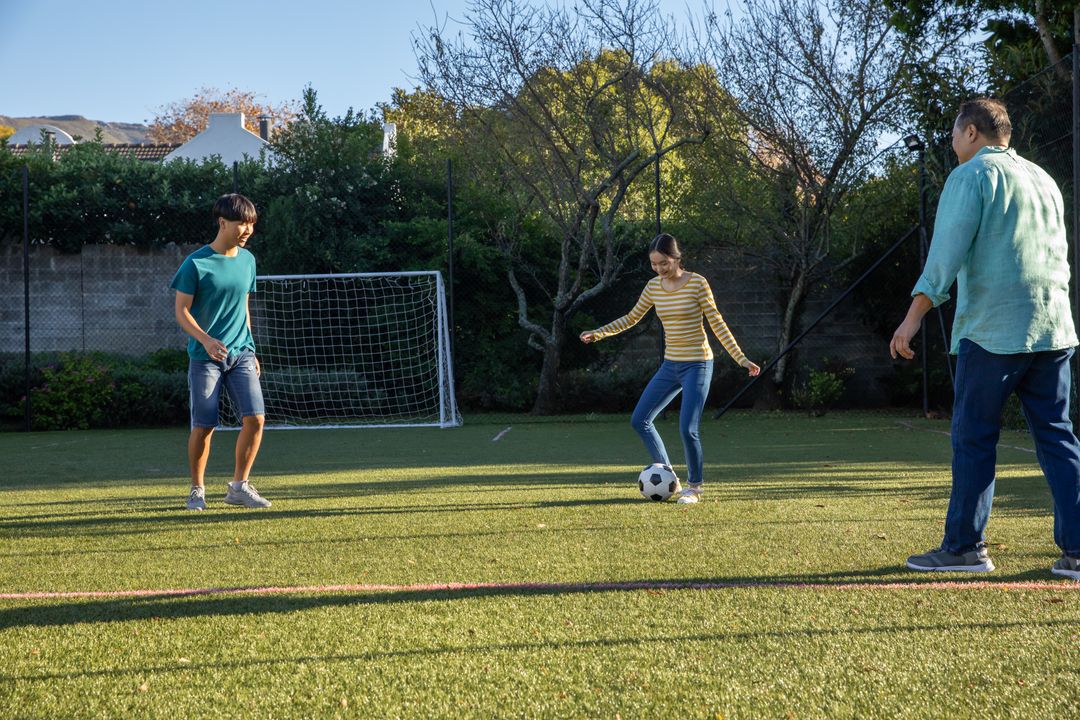 Family Enjoys Outdoor Soccer Game in Backyard