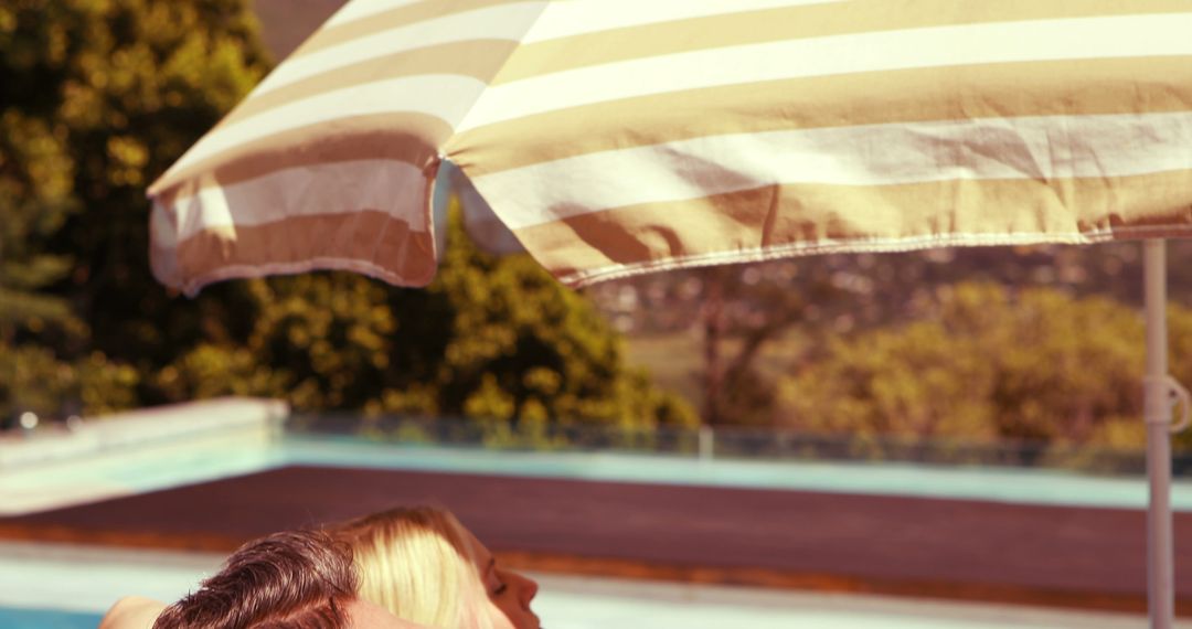 Couple Enjoying Relaxing Sunny Day by Poolside - Free Images, Stock Photos and Pictures on Pikwizard.com