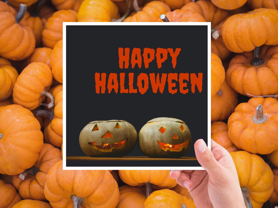 Hand Holding Festive Halloween Sign with Jack-O'-Lanterns and Pumpkins Background - Download Free Stock Templates Pikwizard.com