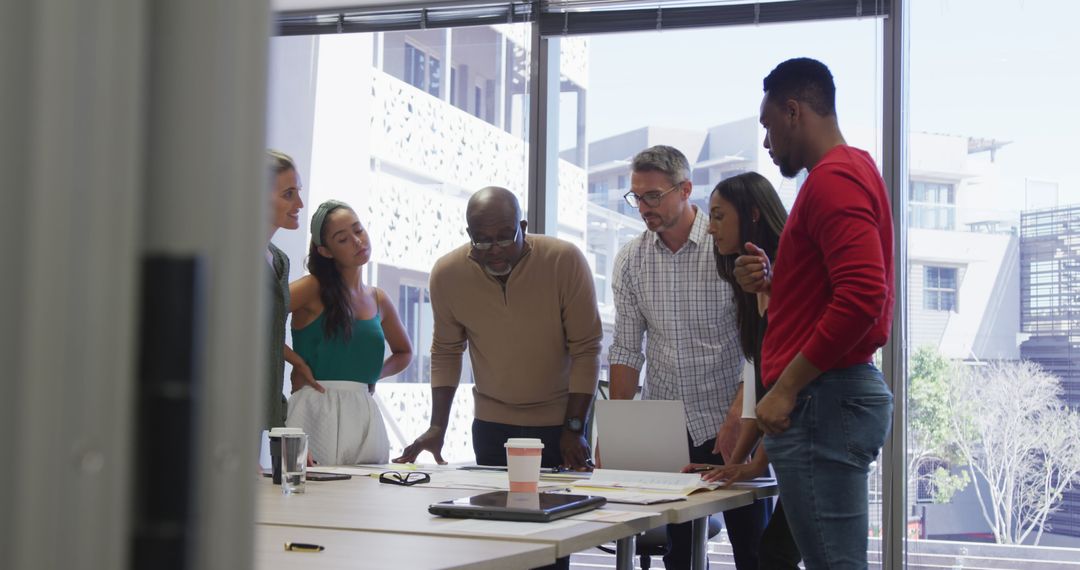 Diverse Team Collaborating on Strategy in Modern Office