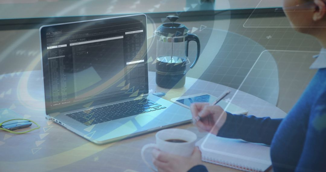 Person Engaged in Remote Work with Data on Laptop and Coffee