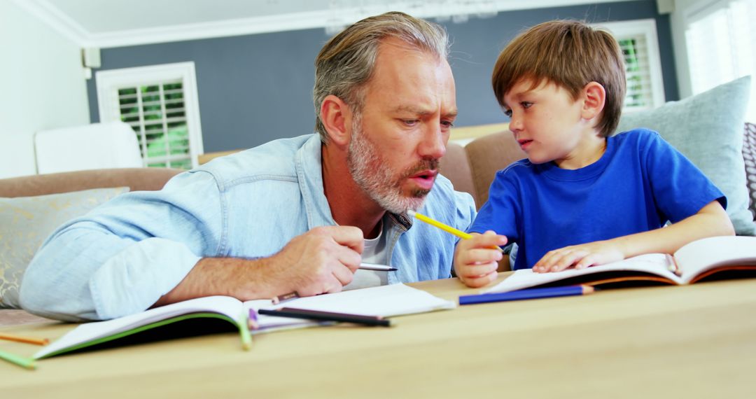 Father and Son Studying Together at Home - Free Images, Stock Photos and Pictures on Pikwizard.com