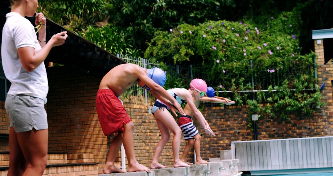 Children Diving into Pool during Summer Swim Practice with Coach - Free Images, Stock Photos and Pictures on Pikwizard.com