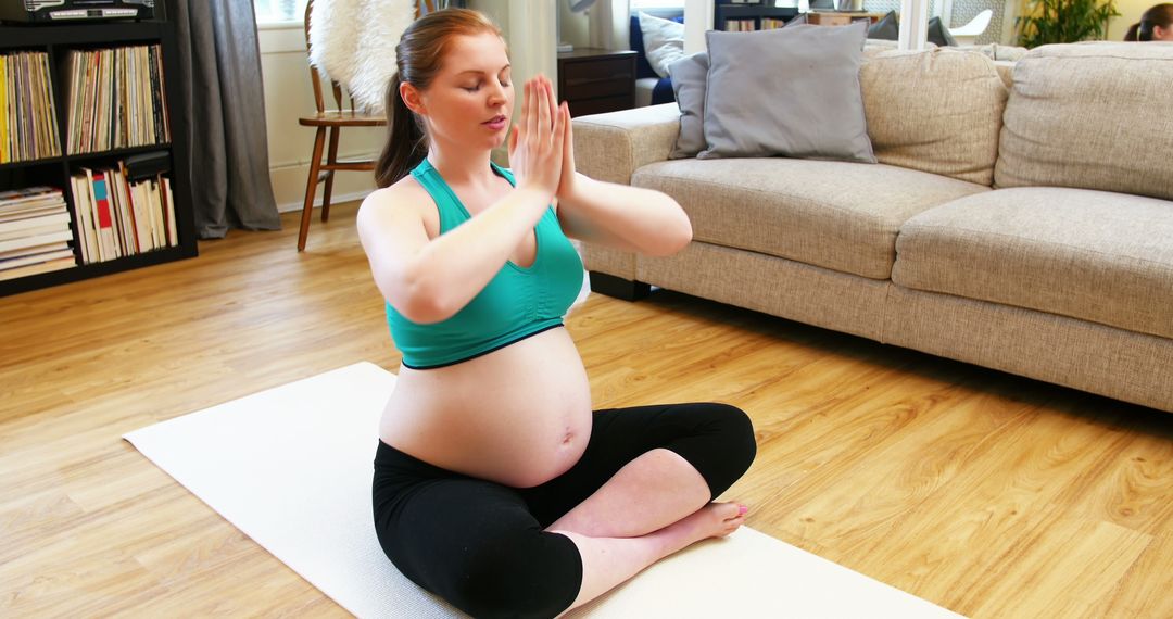 Pregnant Woman Practicing Yoga in Living Room for Relaxation - Free Images, Stock Photos and Pictures on Pikwizard.com