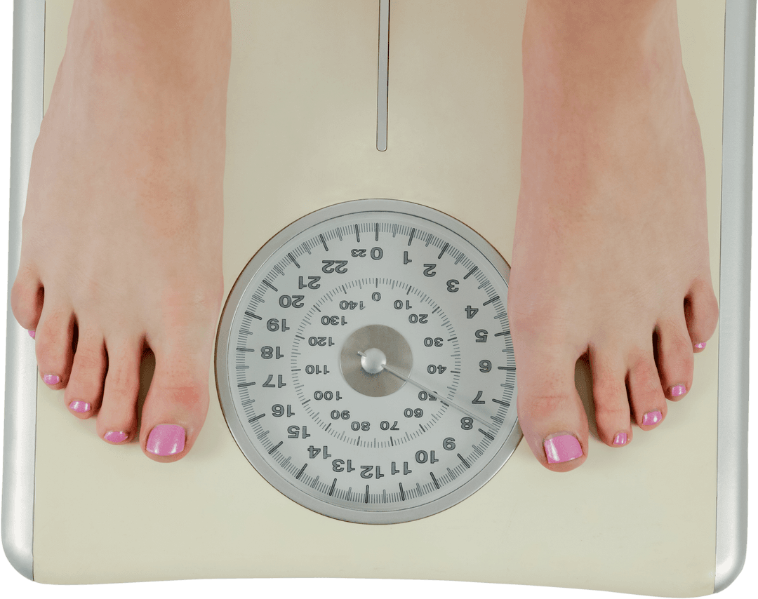 Close-up of Transparent Scale with Female Feet Indicating Weight Measurement
