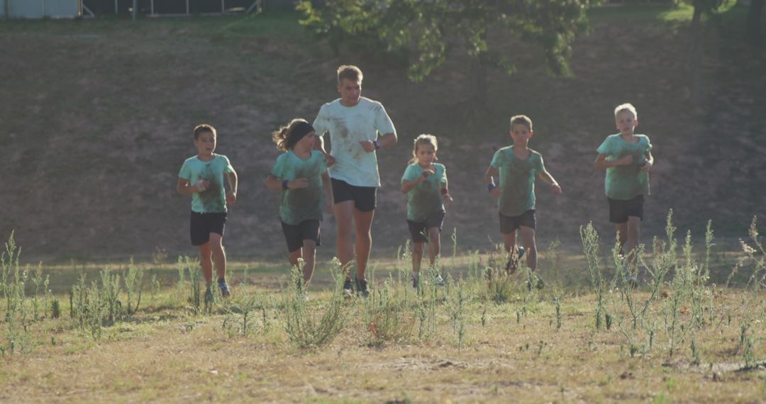 Coach Running with Children in Outdoor Boot Camp - Free Images, Stock Photos and Pictures on Pikwizard.com