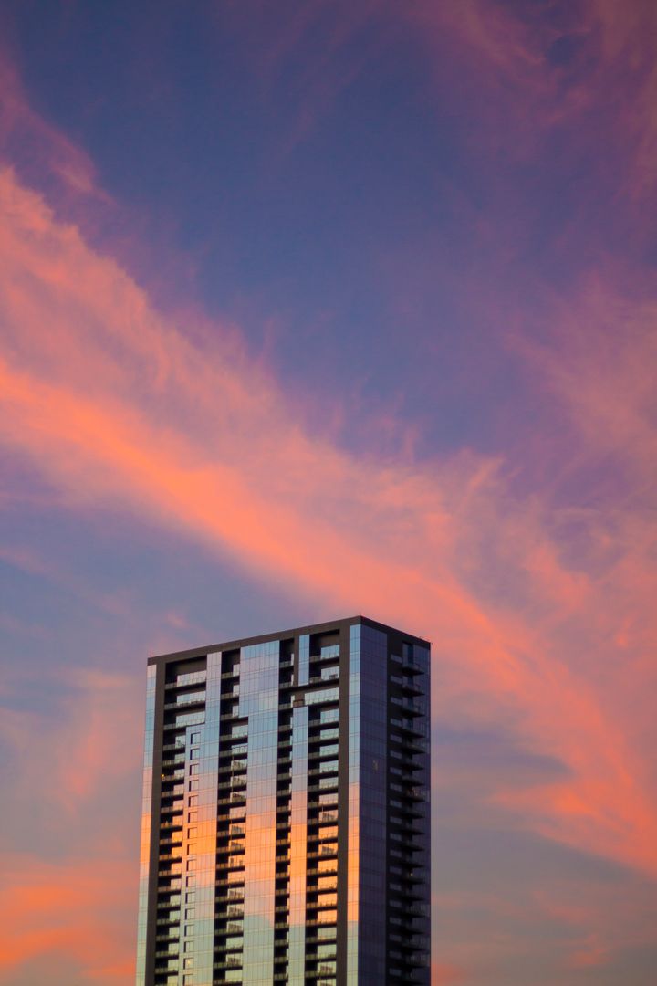 High-rise Building at Sunset with Vibrant Sky - Free Images, Stock Photos and Pictures on Pikwizard.com