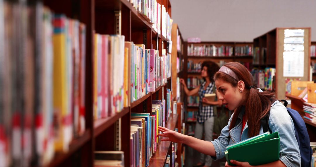 Students Browsing Bookshelves in Library - Free Images, Stock Photos and Pictures on Pikwizard.com