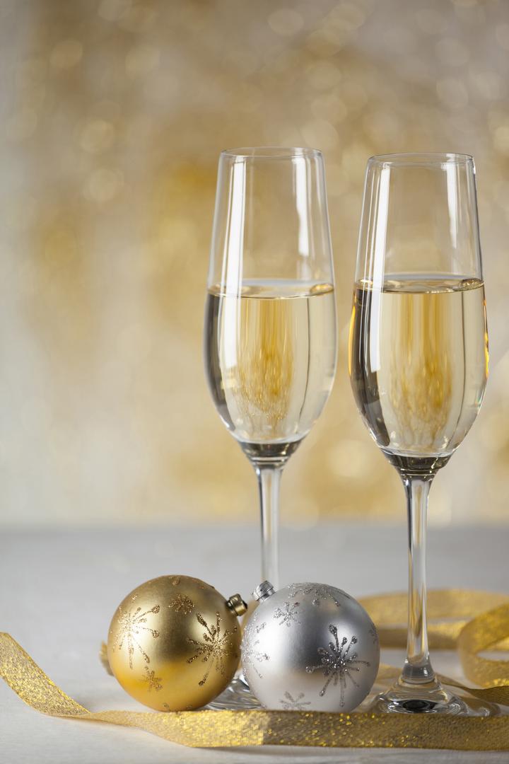 Two champagne flutes and Christmas decoration - Free Images, Stock Photos and Pictures on Pikwizard.com