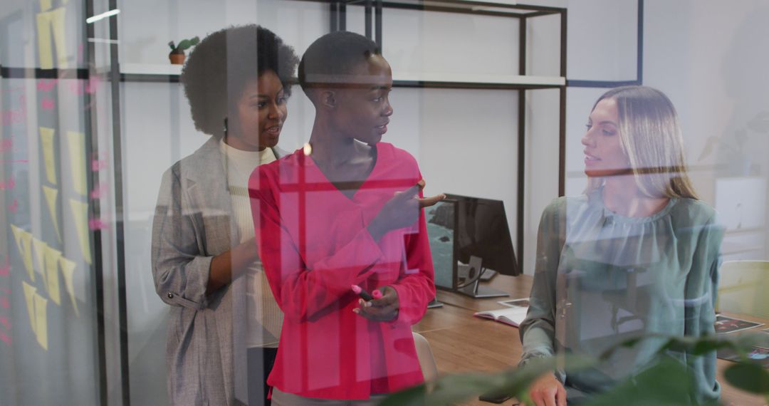 Diverse Businesswomen Brainstorming with Memo Notes in Modern Office