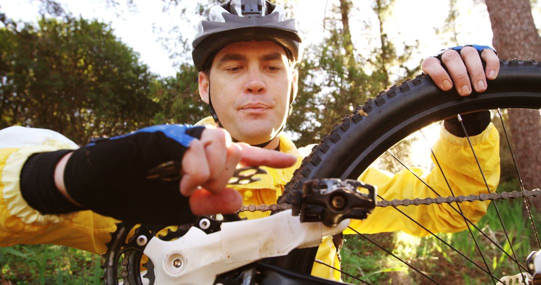 Male Cyclist Performing Maintenance on Mountain Bike Outdoors - Free Images, Stock Photos and Pictures on Pikwizard.com