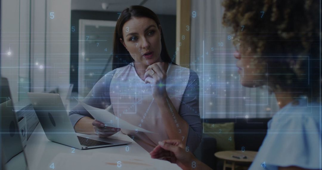 Businesswomen Analyzing Data with Digital Interface in Modern Office