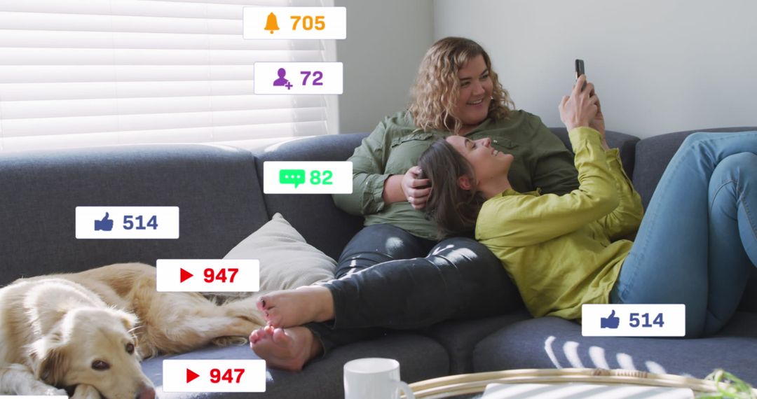 Two Women Relaxing on Couch Engaged with Social Media Notifications
