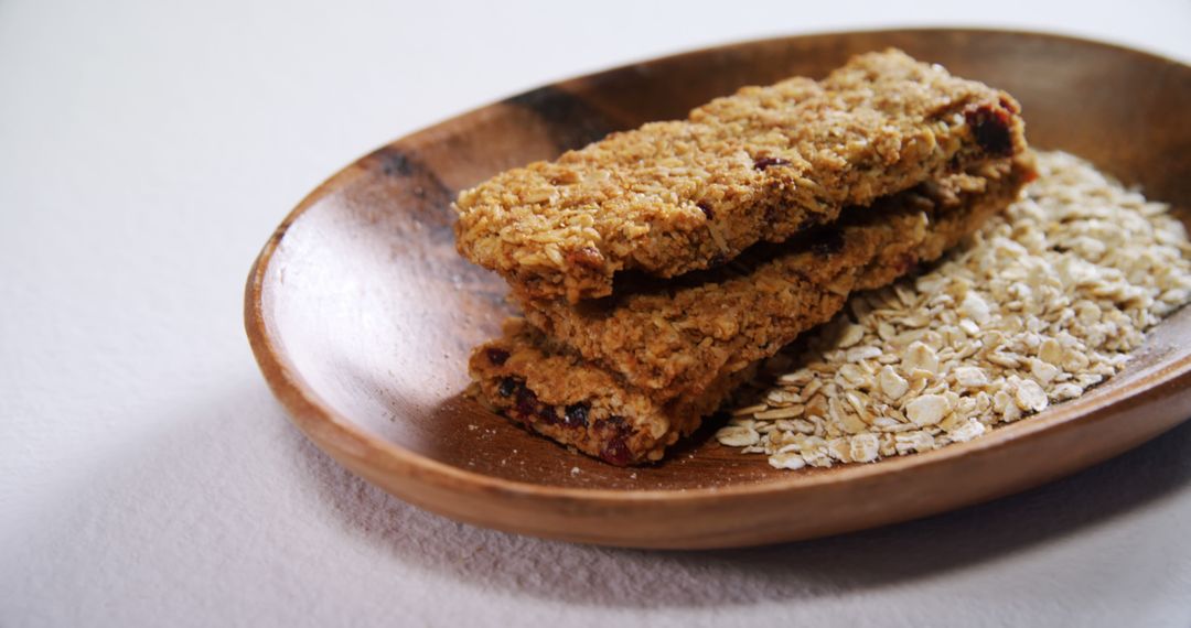 Healthy Granola Bars on Wooden Plate with Oats - Free Images, Stock Photos and Pictures on Pikwizard.com