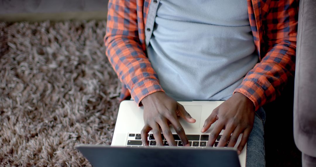 Person Typing on Laptop While Sitting on Carpet - Free Images, Stock Photos and Pictures on Pikwizard.com