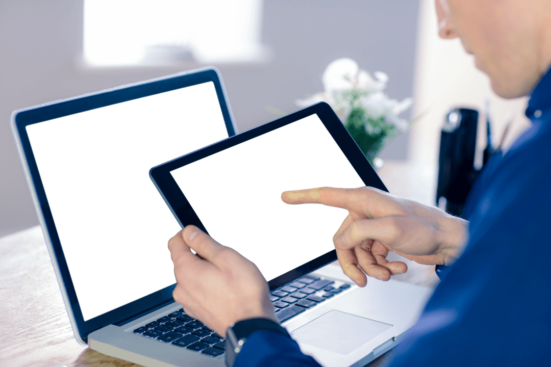 Businessman Using Transparent Tablet and Laptop in Office