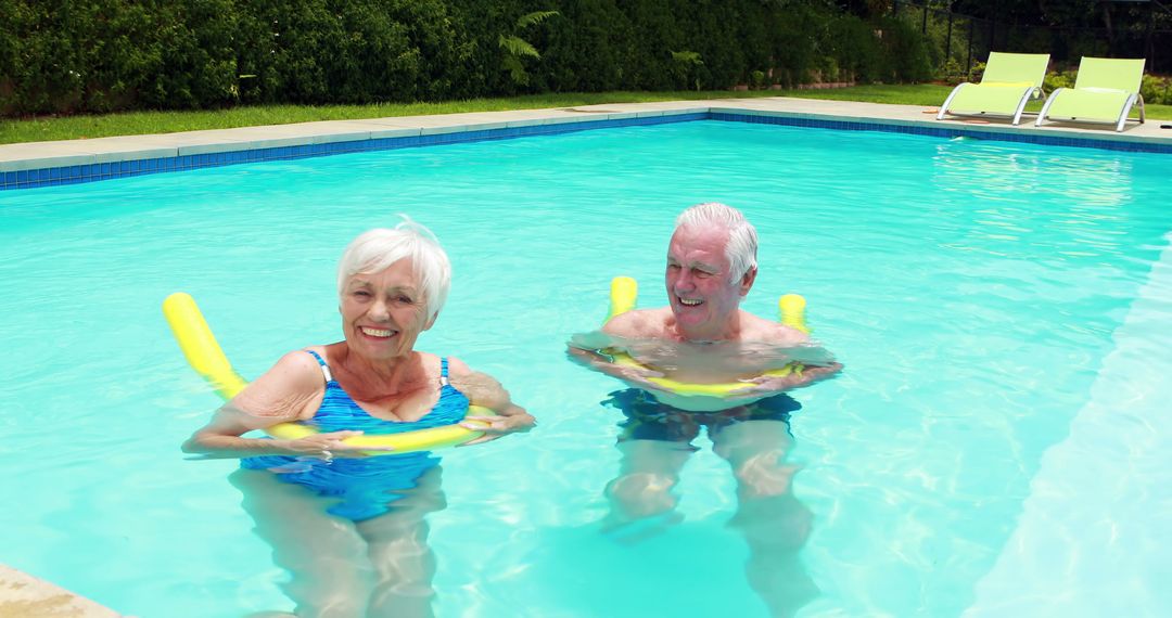 Seniors Enjoying Water Activities in Outdoor Pool on Floating Noodles - Free Images, Stock Photos and Pictures on Pikwizard.com