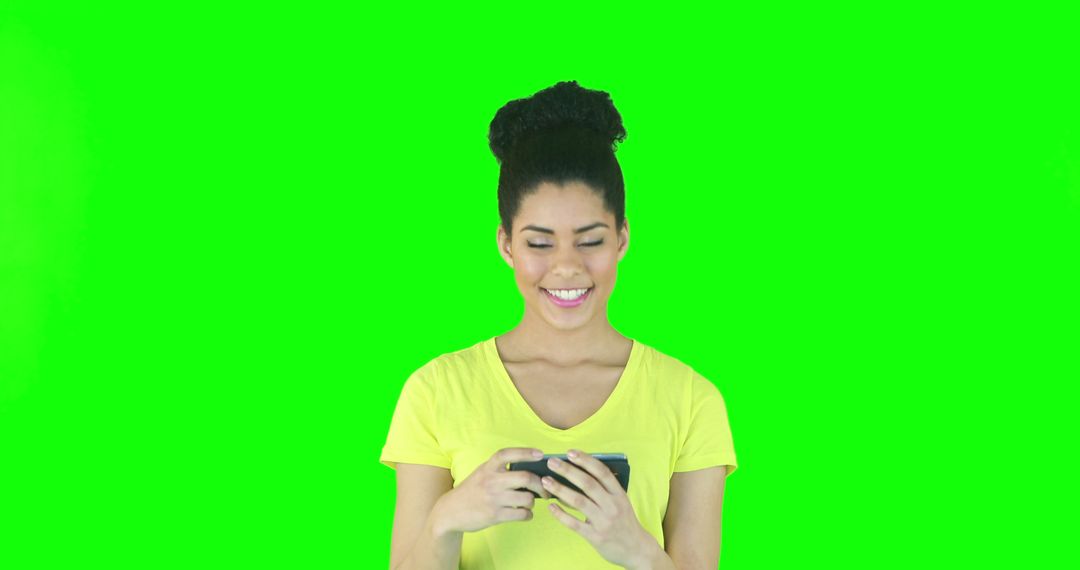 Smiling Woman Using Smartphone Against Green Chroma Key Background - Free Images, Stock Photos and Pictures on Pikwizard.com