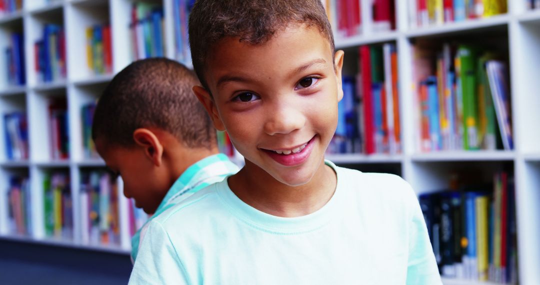 Smiling Boy in School Library with Colorful Bookshelves - Free Images, Stock Photos and Pictures on Pikwizard.com