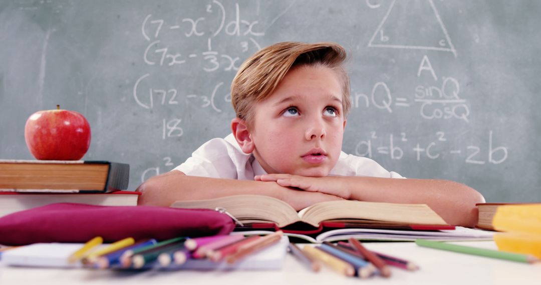 Thoughtful Schoolboy Resting in Classroom Setting