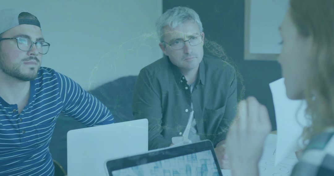 Team Collaborates in Modern Office with Analytical Charts