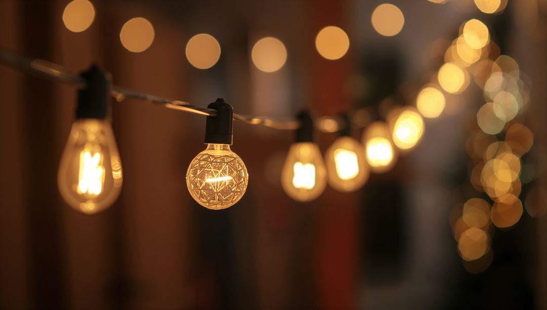 Vintage string lights casting golden bokeh and cozy patio evening ambiance