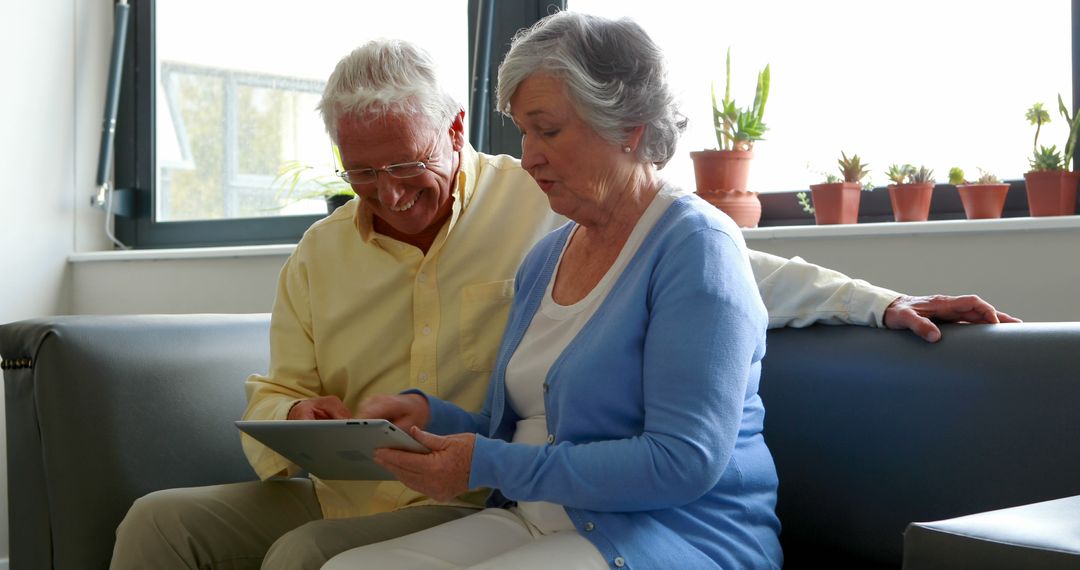 Seniors Using Tablet for Online Communication in Cozy Living Room - Free Images, Stock Photos and Pictures on Pikwizard.com