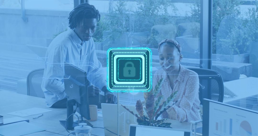 Office team collaborating on cybersecurity working on laptops with digital lock overlay