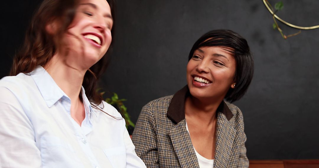 Two Women Laughing and Enjoying Together in Cafe - Free Images, Stock Photos and Pictures on Pikwizard.com