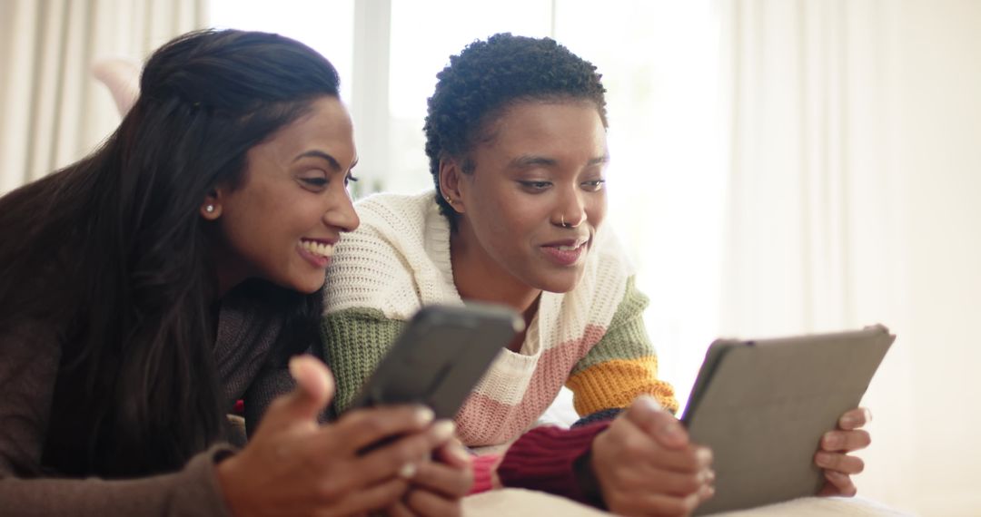 Diverse Female Friends Enjoying Tech at Home