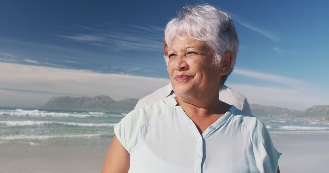 Elderly Woman Relaxing on Beach with a Serene Smile - Free Images, Stock Photos and Pictures on Pikwizard.com