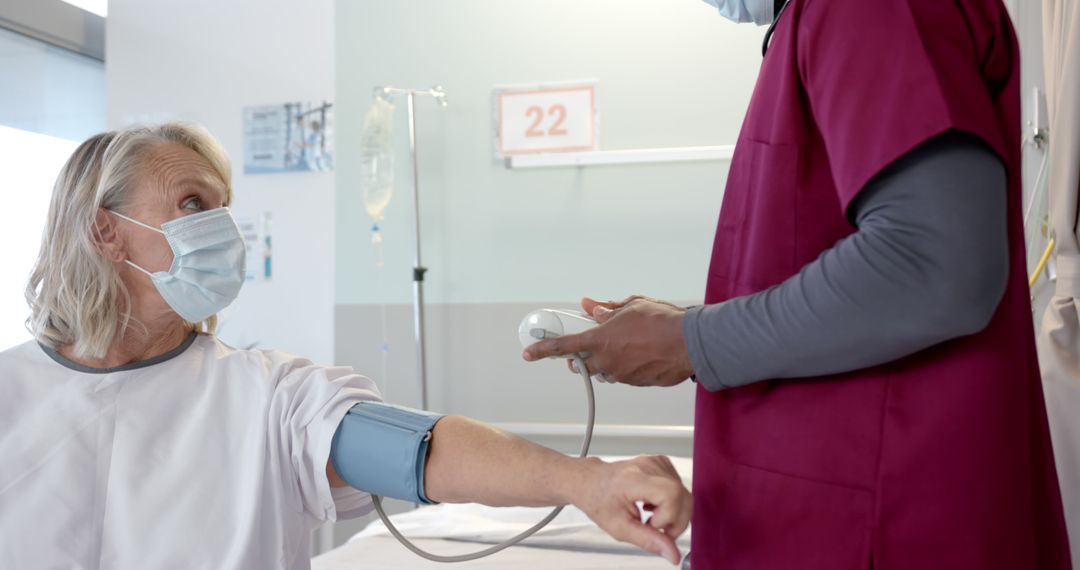 Nurse checking blood pressure of female patient during medical examination in hospital - Free Images, Stock Photos and Pictures on Pikwizard.com