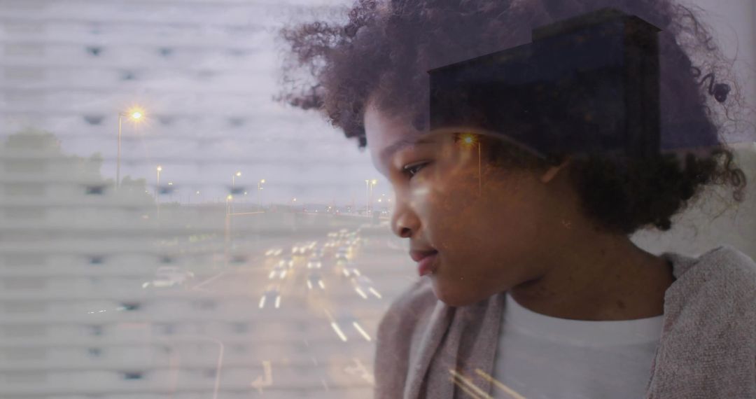 Curly-haired child gazing through blinds at highway light trails double exposure dusk mood