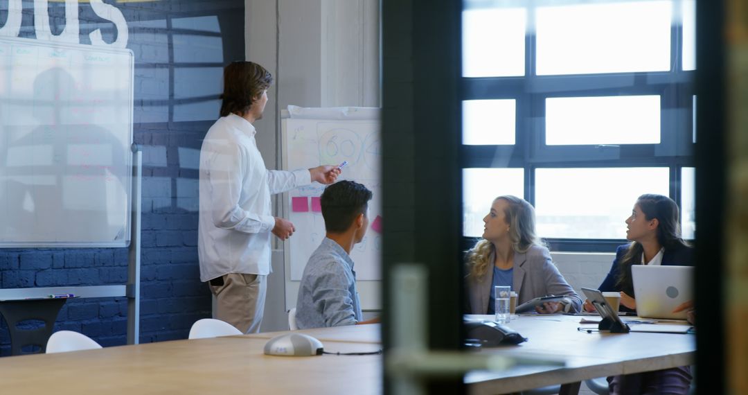Collaborative Team Meeting Analyzing Business Strategies in Modern Office