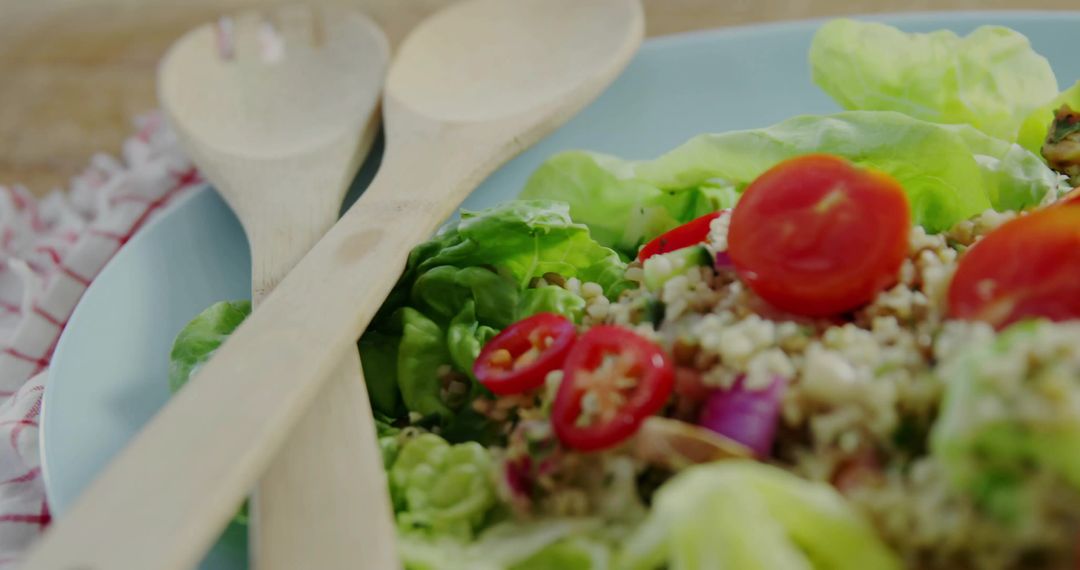 Fresh Quinoa Salad with Wooden Spoons on Rustic Table