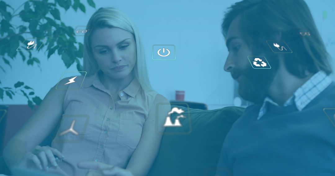 Coworkers Collaborating with Interactive Floating Icons in Modern Workspace