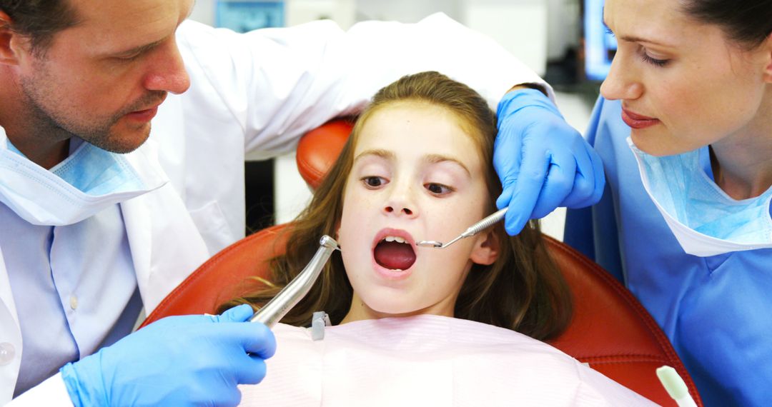 Dentists Examining Young Patient in Dental Clinic - Free Images, Stock Photos and Pictures on Pikwizard.com