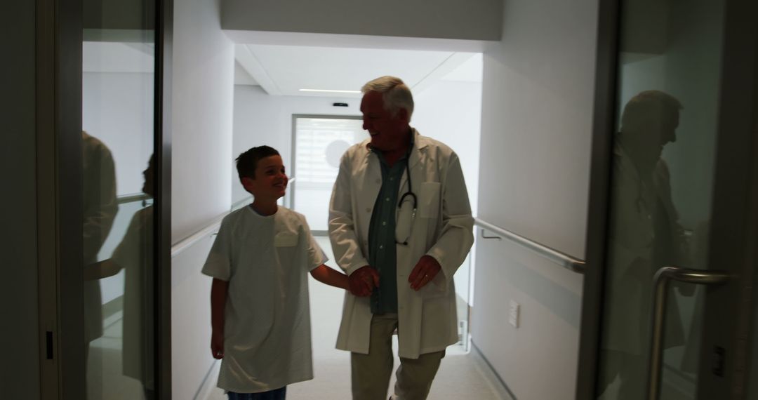 Doctor and young patient walking in hospital hallway - Free Images, Stock Photos and Pictures on Pikwizard.com