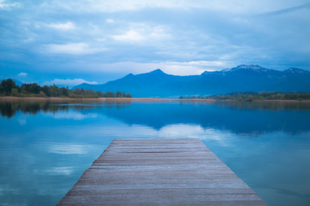 Tranquil Lake with Wooden Pier and Mountain View - Free Images, Stock Photos and Pictures on Pikwizard.com