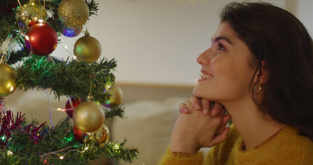 Woman Admiring Decorated Christmas Tree with Joyful Expression - Free Images, Stock Photos and Pictures on Pikwizard.com