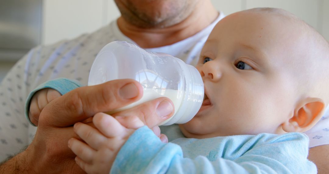 Parent Feeding Bottle to Infant at Home - Free Images, Stock Photos and Pictures on Pikwizard.com