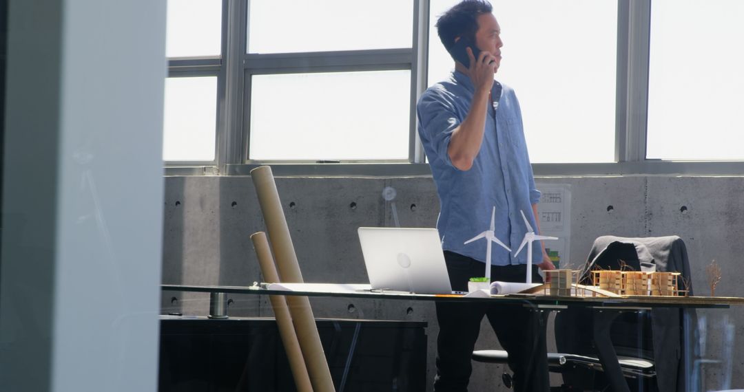 Architect Discussing Project on Phone in Modern Office