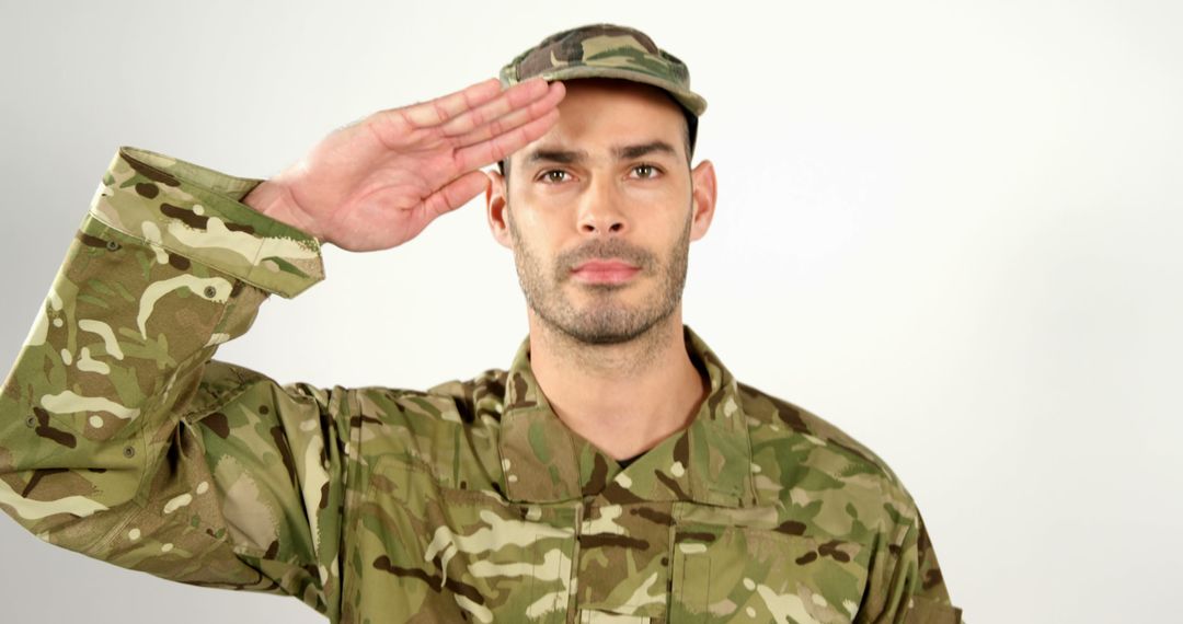 Young Male Soldier in Uniform Saluting with Respect and Honor