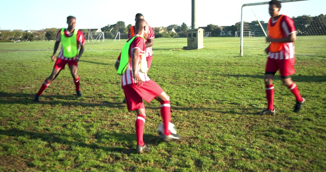 Soccer Team Training Game with Fluorescent Bibs on Grass Field