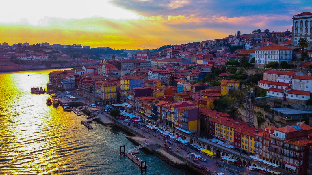 Aerial View of Colorful Riverside Buildings at Sunset in Porto, Portugal - Free Images, Stock Photos and Pictures on Pikwizard.com