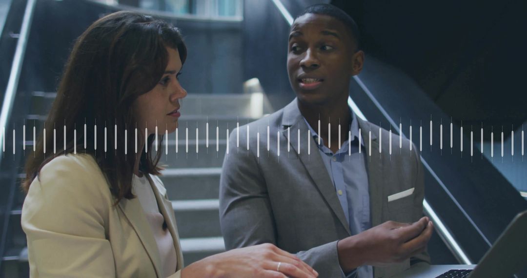 Professional Business Discussion in Office Setting with Laptop