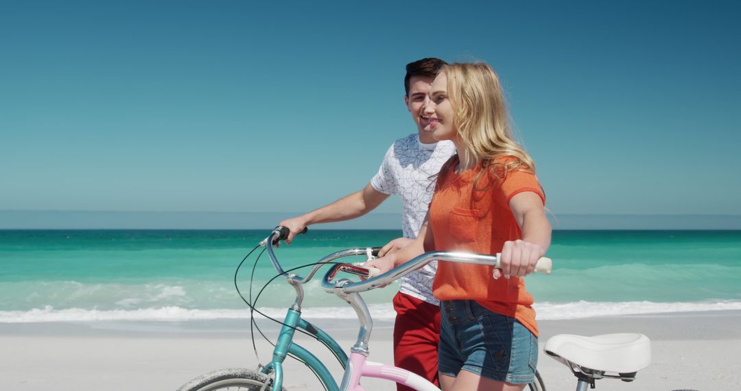 Joyful Couple Enjoying Cyclist Adventure on Sunlit Beach - Free Images, Stock Photos and Pictures on Pikwizard.com