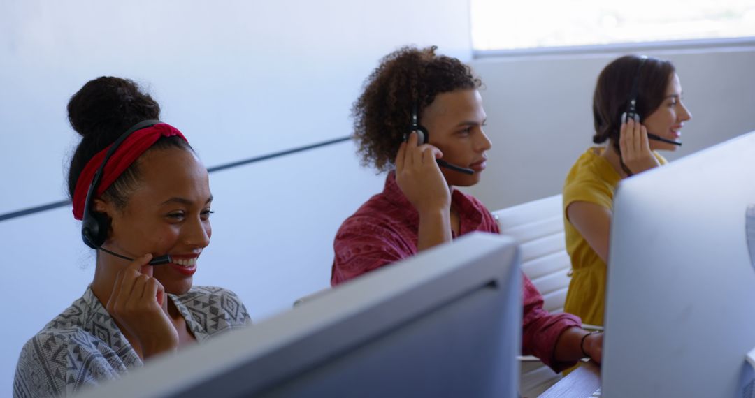 Multicultural Call Center Agents on Headsets in Modern Office